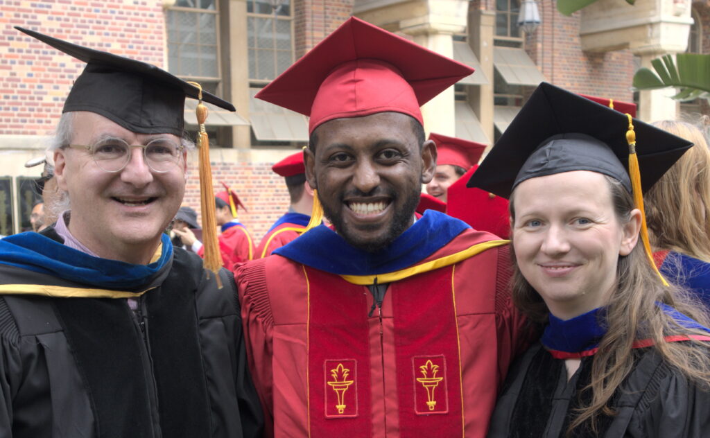 Basileal Imana at his PhD hooding with his thesis advisors.